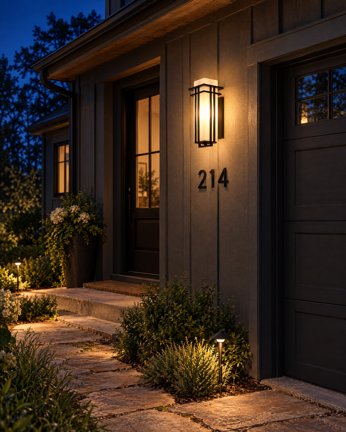 Foundry sconce lighting a house number and stone path at night