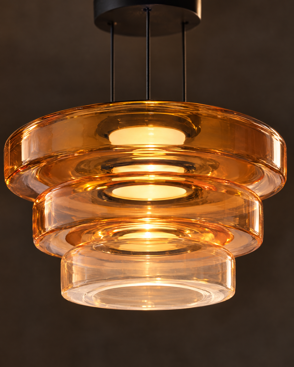 Close-up of layered amber glass rims glowing warm