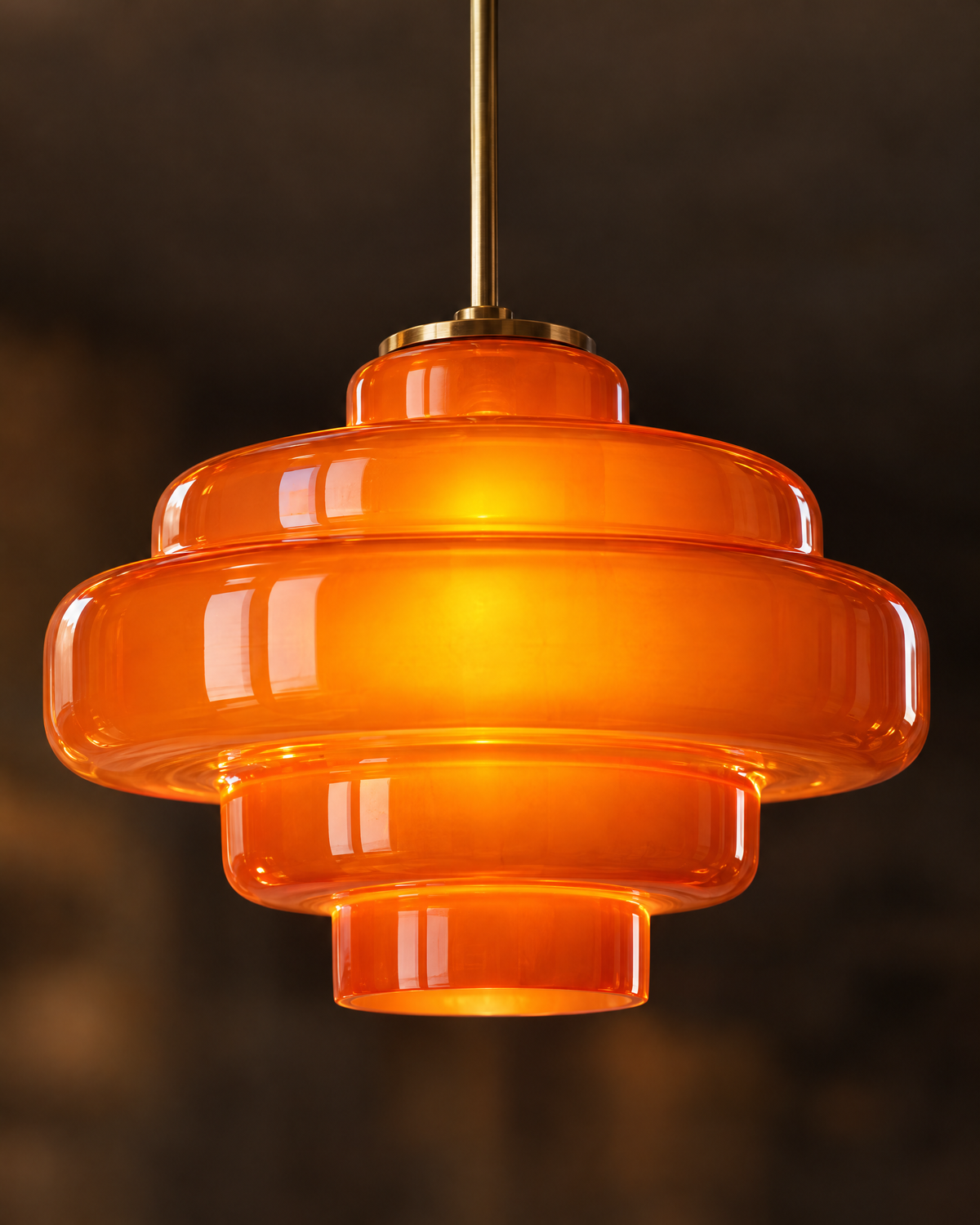 Close-up of glossy orange tiered glass glowing warm